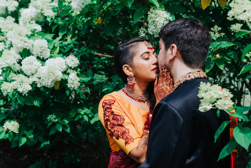 bride-and-groom-kissing-in-bushes