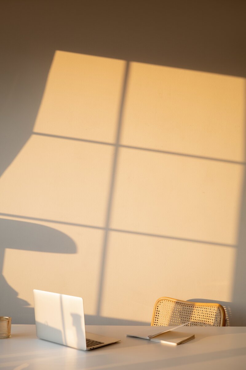 computer sitting on desk with shadow