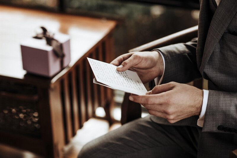 Emotional groom reading a heartfelt letter before the wedding ceremony in Raleigh, NC.