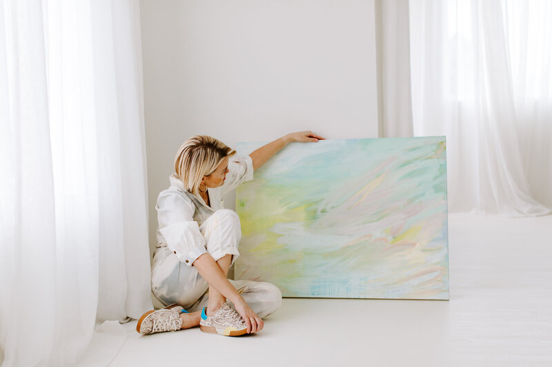 Abstract artist with painting in bright room