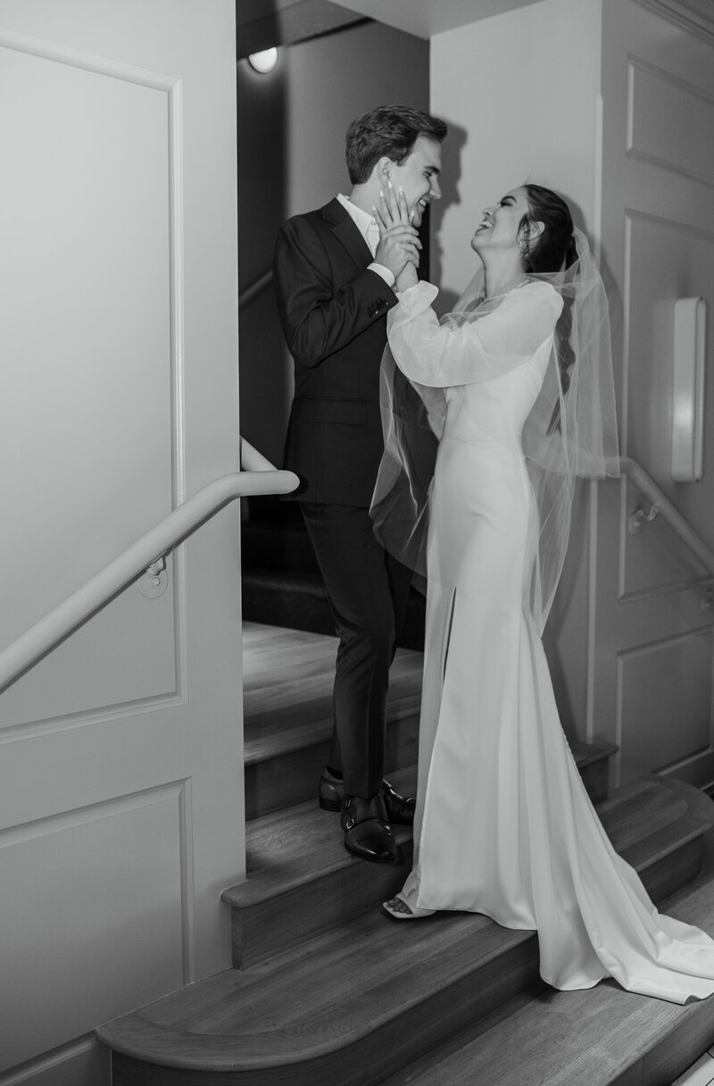 Bride and groom lauding on staircase