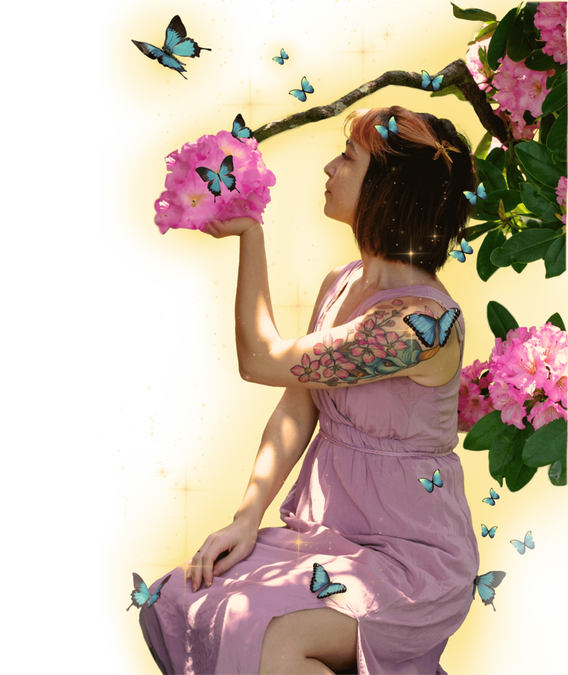 Women in pink greek styled gown holding up pink flowers with left hand as she looks at them blue butterflies are all around her and golden light eminates from woman and butterflies