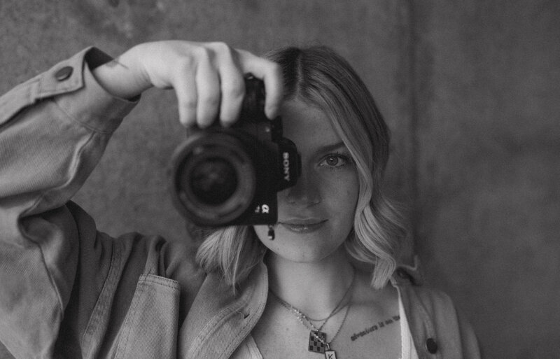 Kamryn holding her camera, capturing moments in North Idaho.