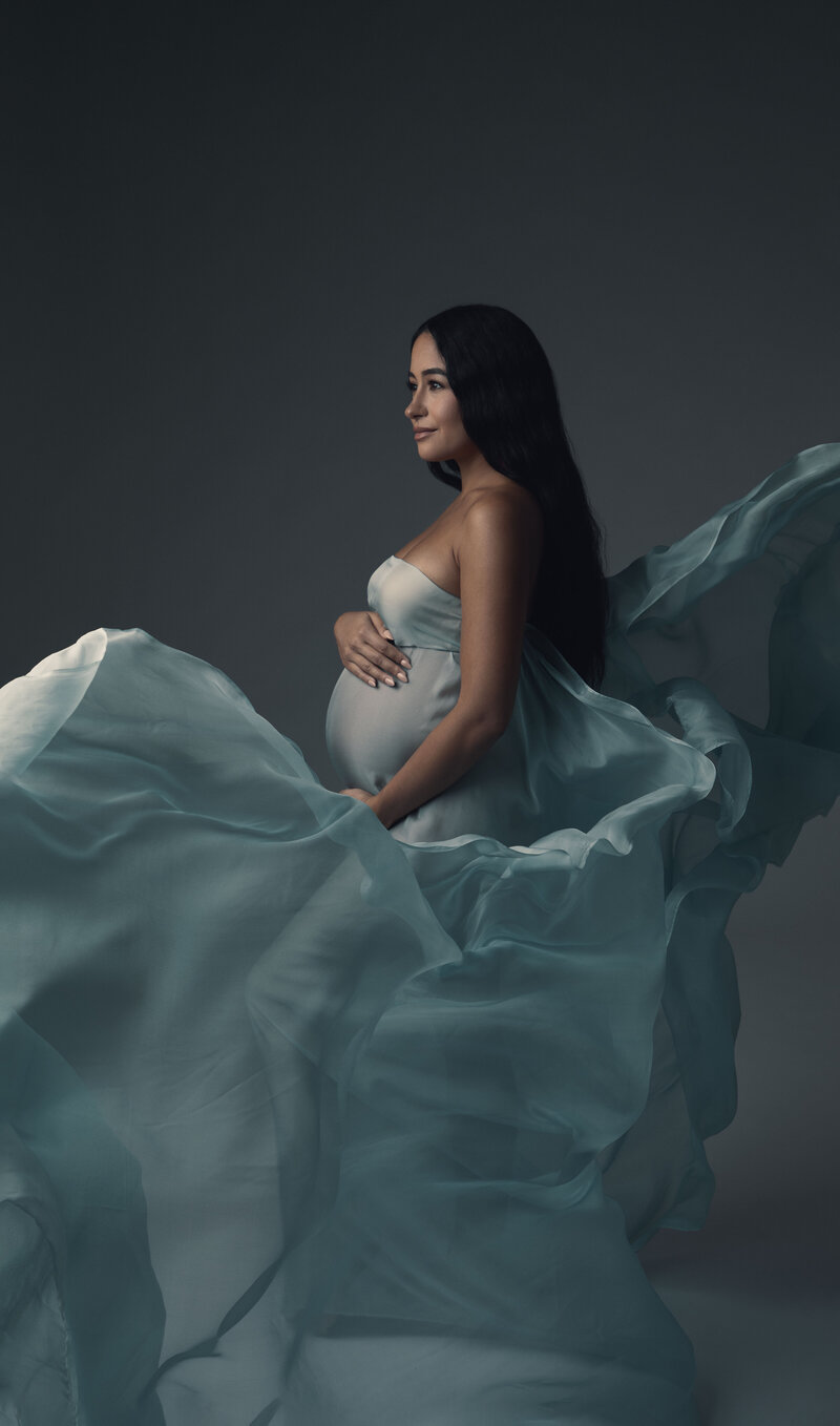 Maternity session with a flying blue dress