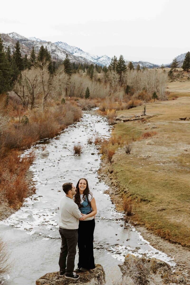 Adventurous couple hiking to a mountain overlook during their Lake Tahoe session