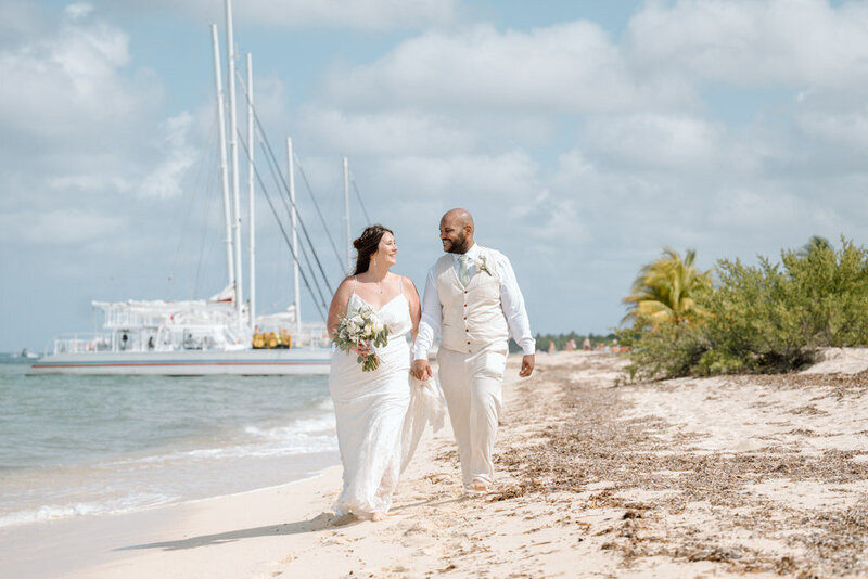 a couple walks along the beach at their wedding at Mr Sanchos in Cozumel