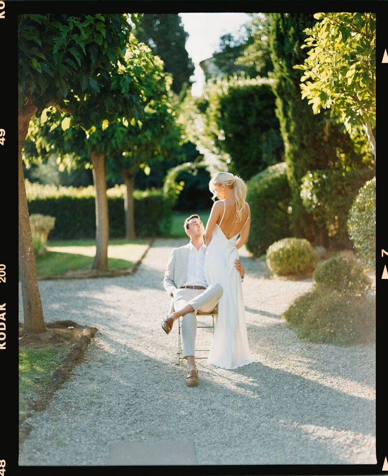 Groom fixes watch while looking out window