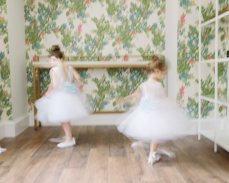 flower girls spinning and dancing in white dresses