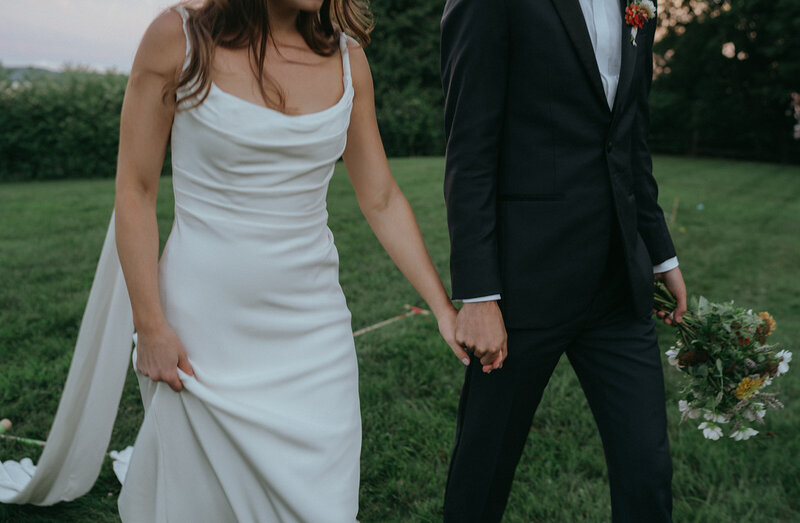 bride and groom walking captured by vermont wedding photographer elsie goodman
