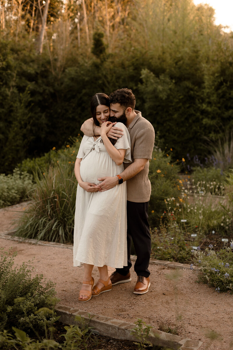 San Antonio pregnant woman portrait begin hugged from behind by husband