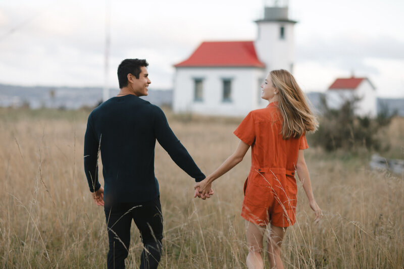 Engagement session on Point Robinson on Vashon Island with lighthouse visible.
