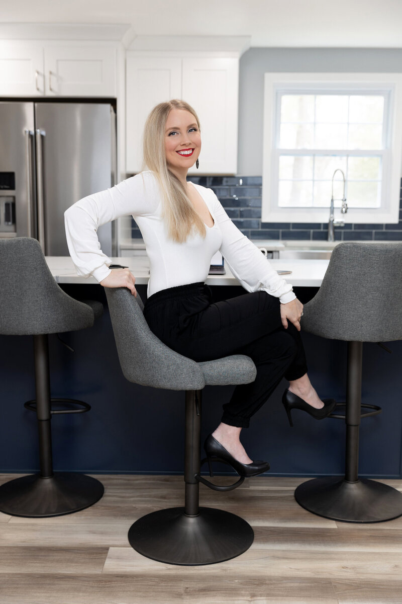 Kristyn sitting at a chair in her kitchen