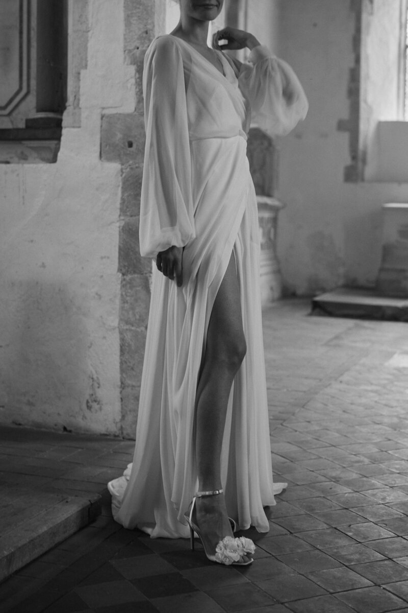 Flowing georgette silk wedding dress by bridal designer Luna Bea, worn by bride in church