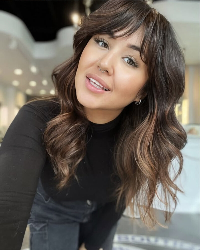 Smiling stylist with new fringe and colour