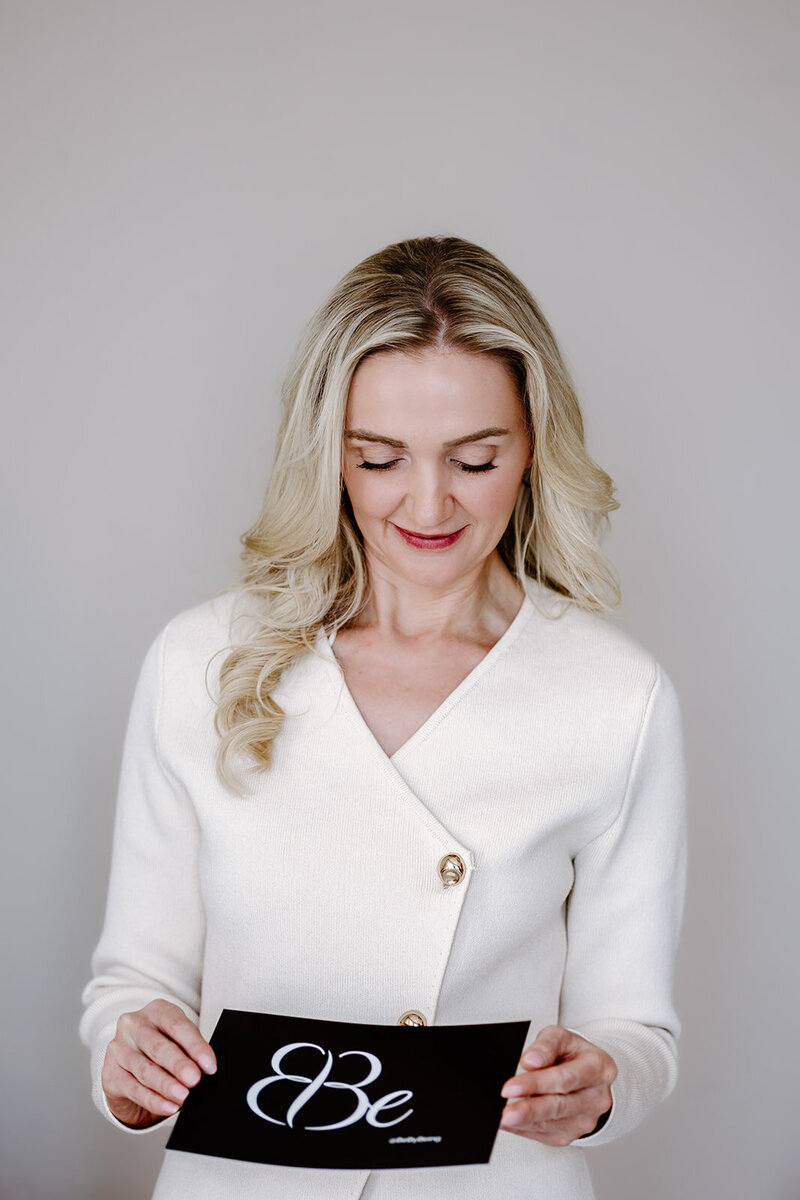 Female coach wearing a cream suit