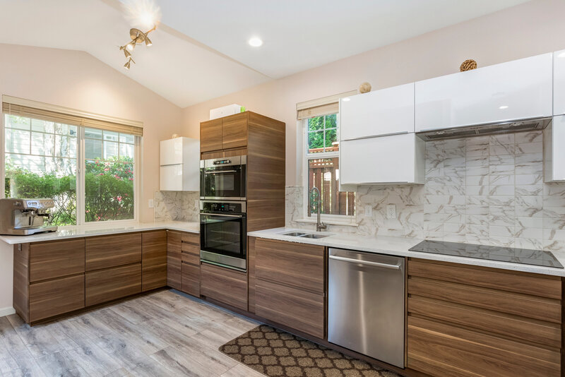 Unique kitchen design with different wood textures for the cabinetry and flooring. 