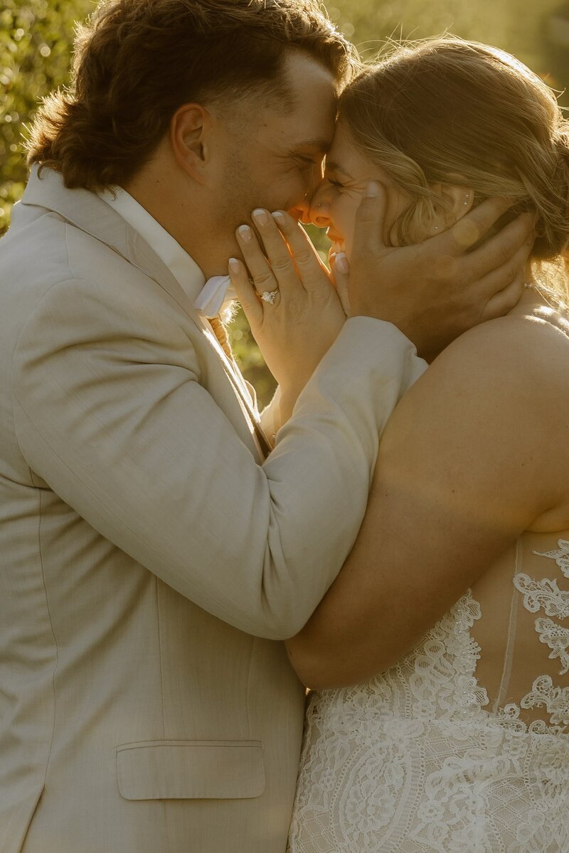 Joy-filled moment as the bride and groom tenderly pull their faces close together.