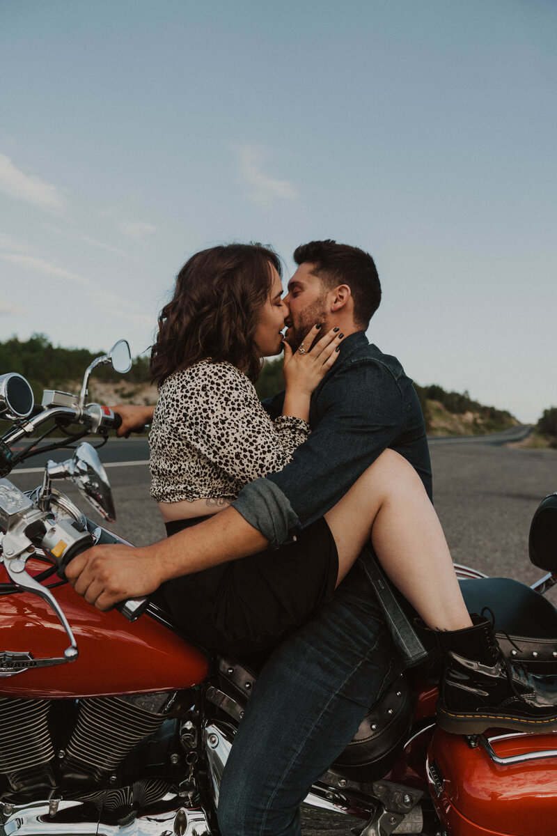 couple on motorcycle kissing