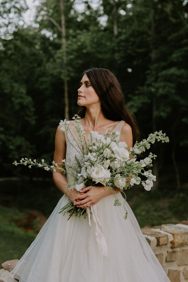 Nashville bride holding a white and green bouquet outdoors