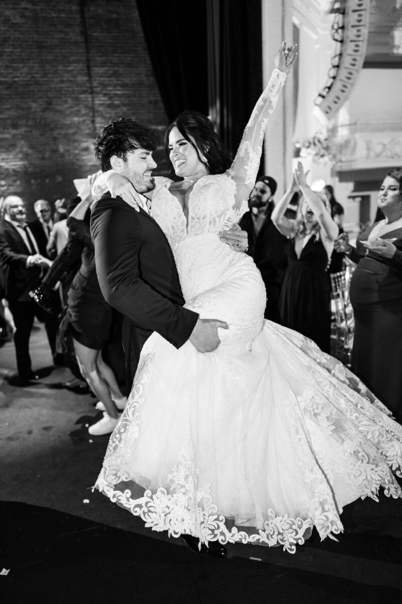 Groom lifts bride during Civic Theatre wedding in New Orleans