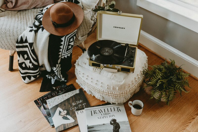 vinyl record by chair with blanket and records