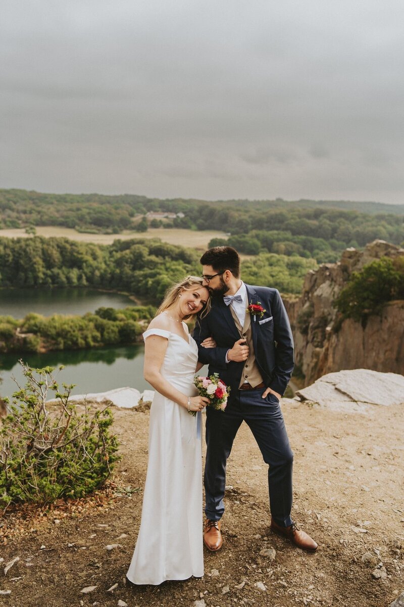 The couple posing on cliffs during their adventure elopement wedding in Scandinavian Bornholm island