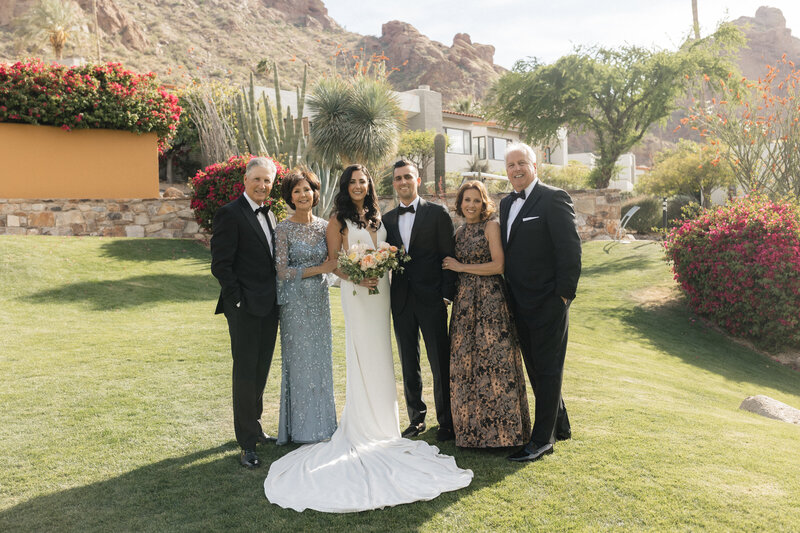 Newlywed couple poses with family for portraits at Sanctuary at Camelback wedding venue in Paradise Valley, Arizona. 