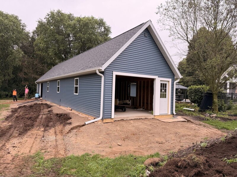 Before: blue detached garage with a dirt apron in Middlebury, IN