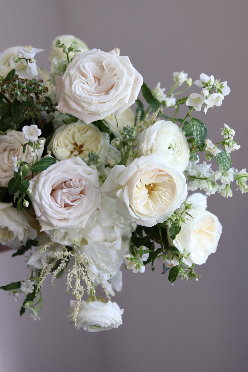 Pretty white wedding bouquet with garden roses.