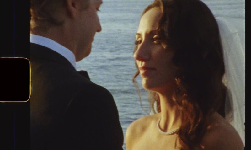 Snapshot from a Boston wedding film of the couple staring at eachother