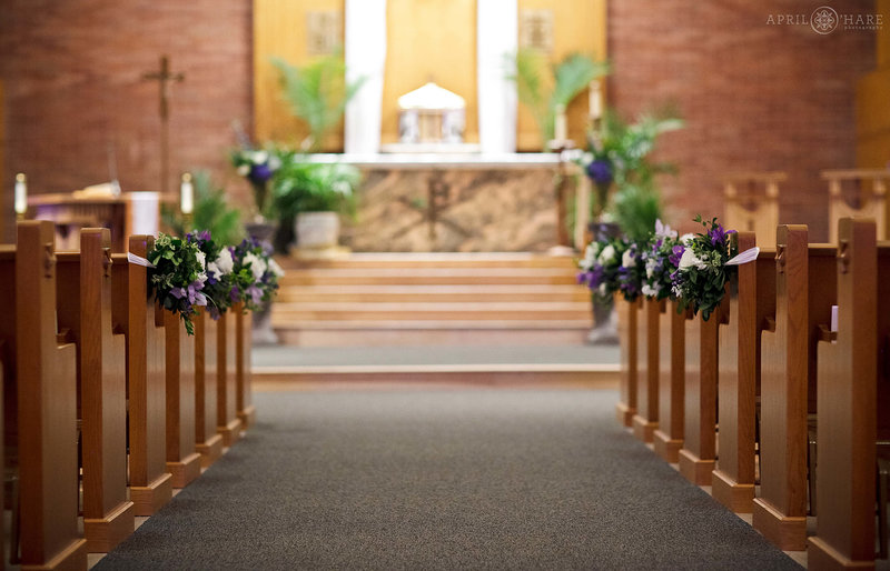 Florals decorate the aisles of St. John the Baptist Catholic Church in Longmont Colorado