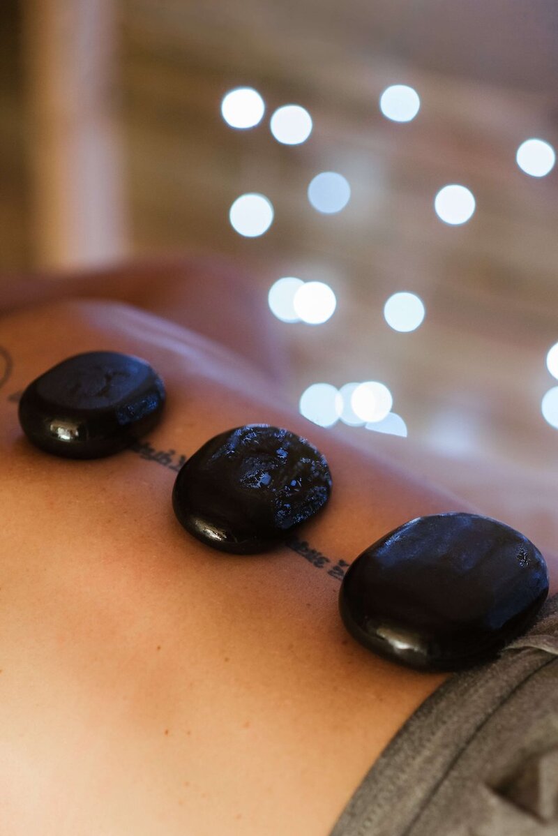 A hot stone massage uses warm, smooth stones placed on the body to melt away tension, improve blood flow, and create a deeply calming and restorative experience.