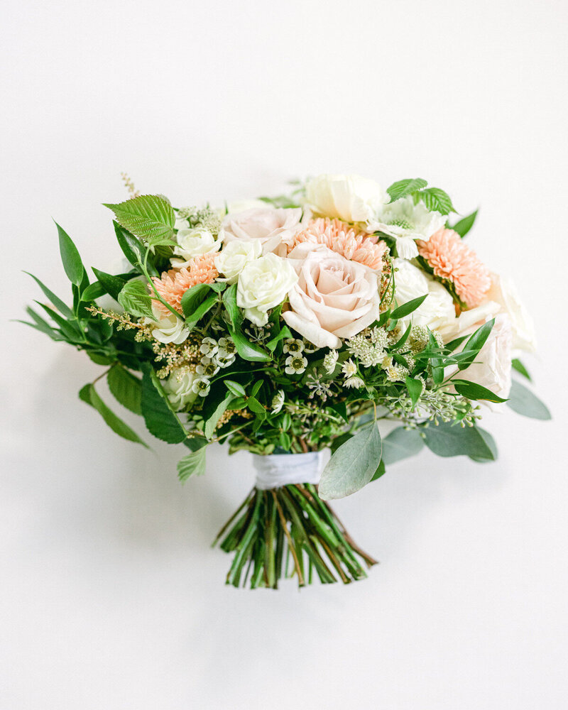 This layflat photo showcases a stunning bridal bouquet from a wedding at Calgary Golf & Country Club, highlighting exquisite floral design in a luxurious setting.