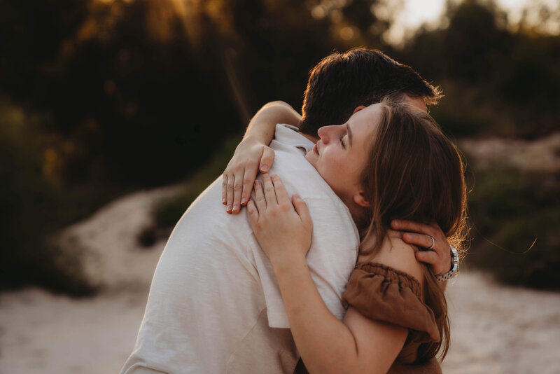 father hugging daughter during an outdoor photo session in The Woodlands Texas