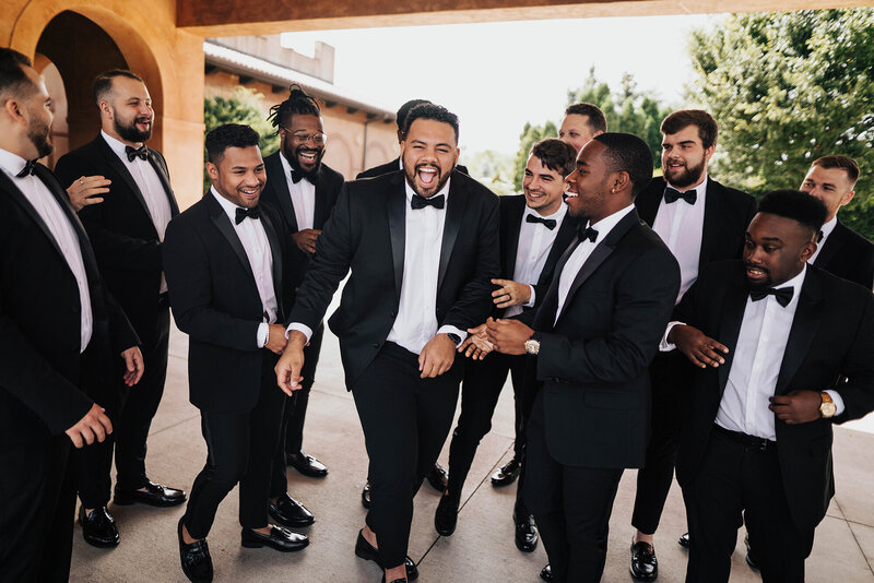groomsmen laughing together