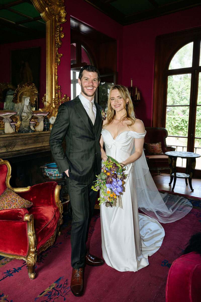 Paramour Estate Bride and Groom  in The Salon. Bride is holding a modern cascading bouquet
