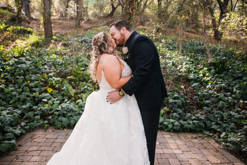 Bride and groom kissing at the Oaks at Duncan Lane