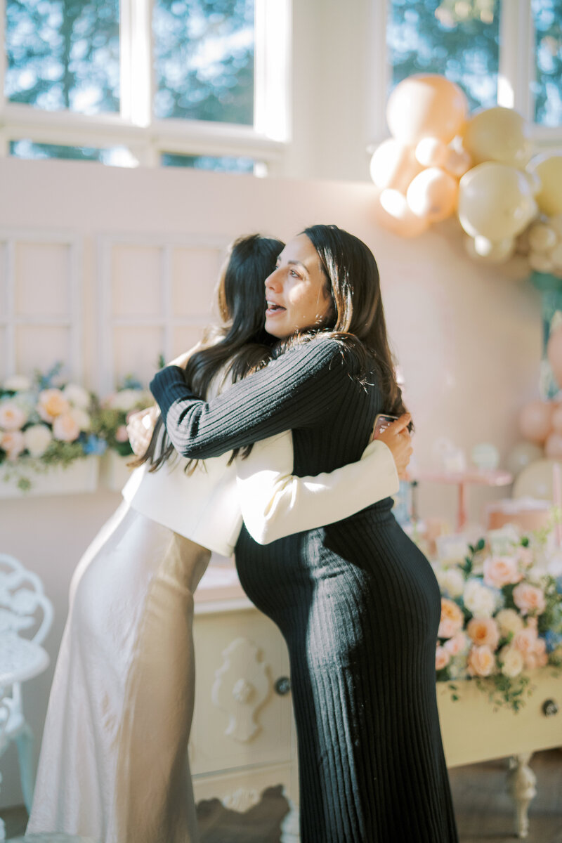 women hugging at baby shower