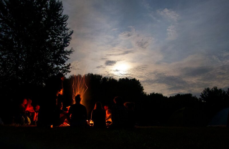 women around a campfire at a retreat