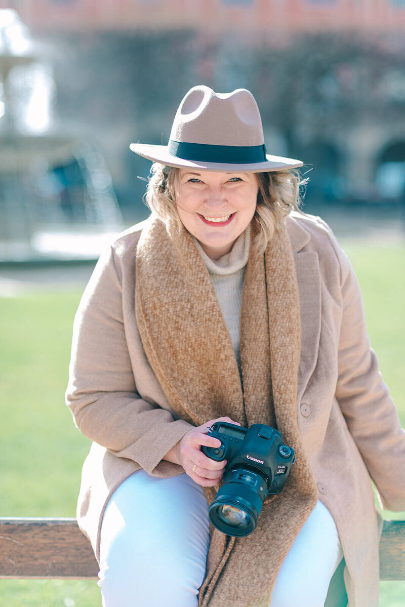 Paris Photographer, Rachael Laporte, smiling and holding camera during Paris Photoshoot