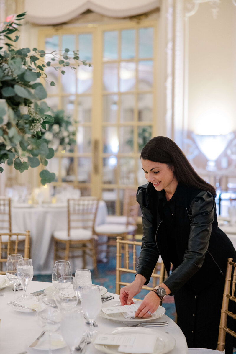 Julie Riley styling a wedding tablescape at Tupper Manor