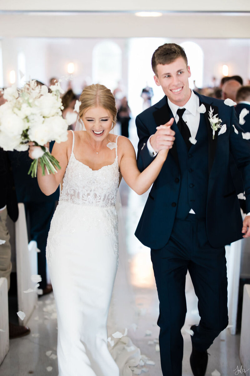 Bride and groom walk down the aisle at the emerson in texas
