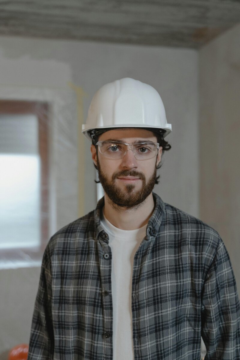 Smiling construction worker in hard hat representing empowered and confident frontline leadership