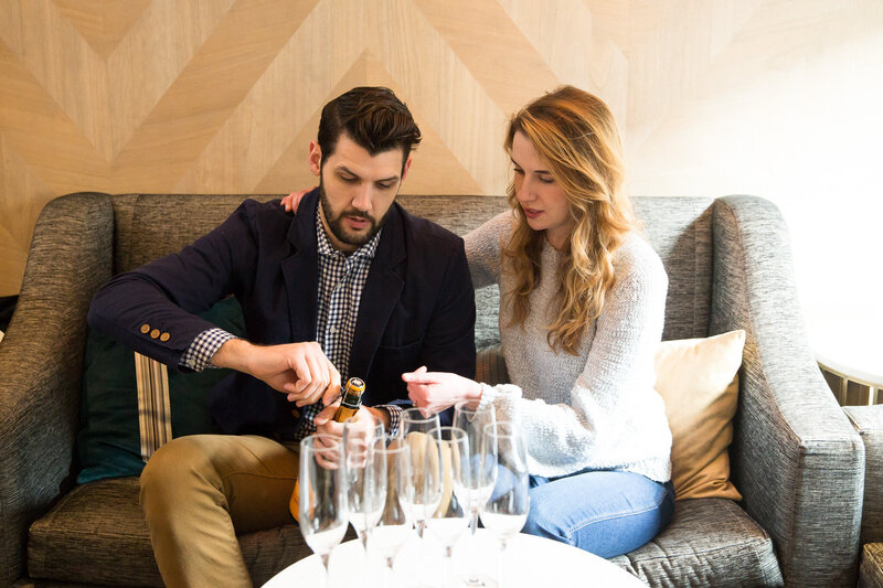 couple pouring champagne celebrating proposal at londonhouse chicago