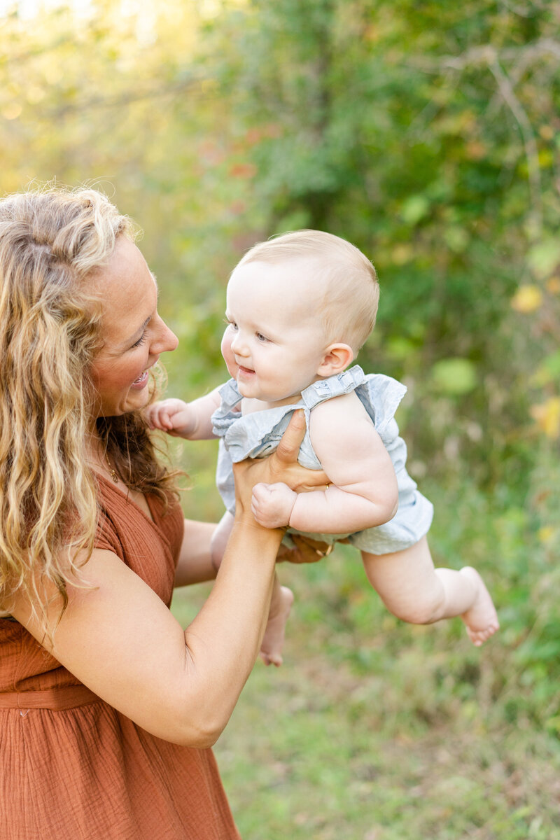 a mother is playing with her toddler