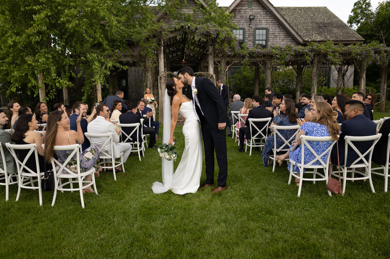 A couple's first kiss after the ceremony at Jedidiah Hawkins Inn in Jamesport, New York on Long Island. 