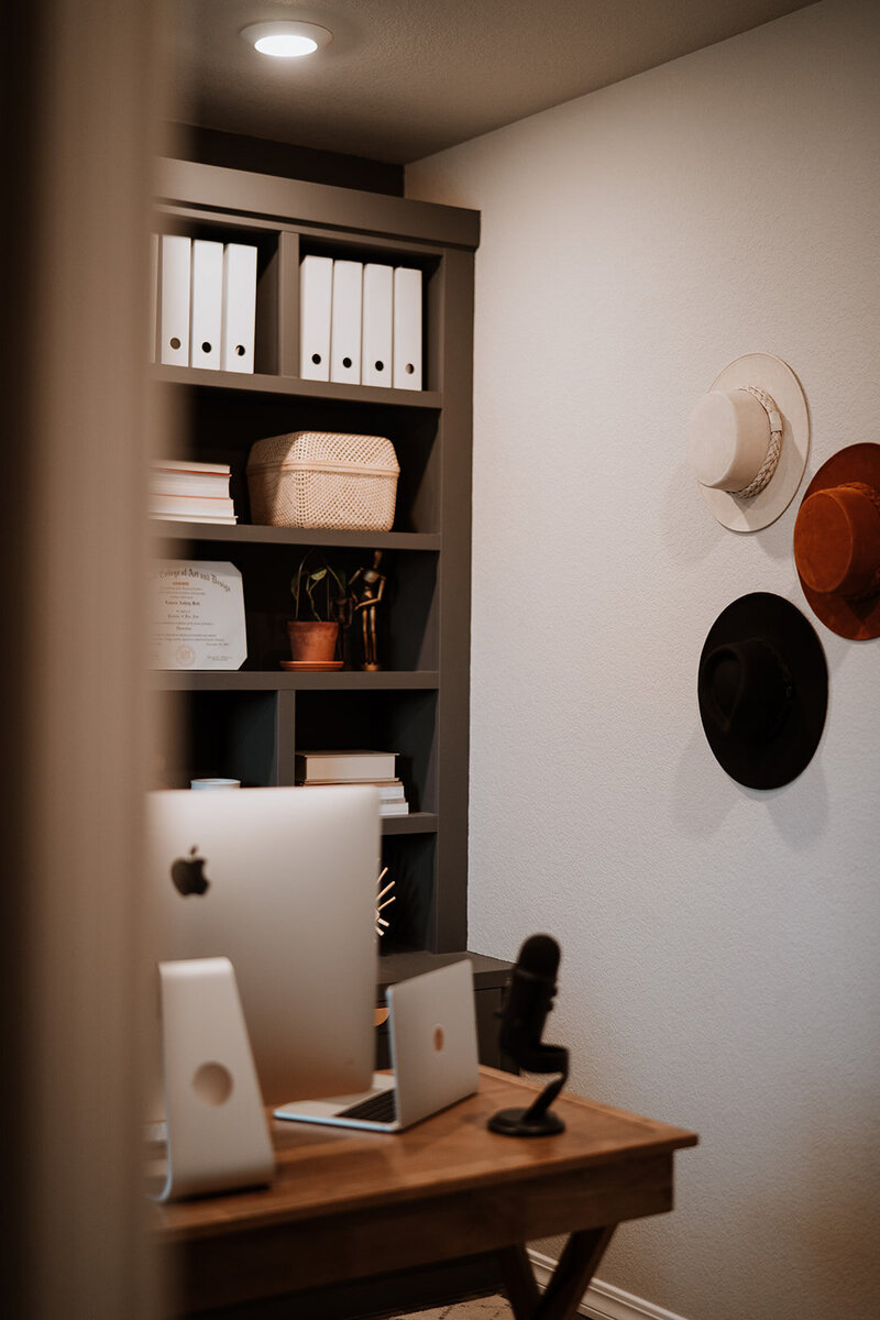 home office with hats on wall