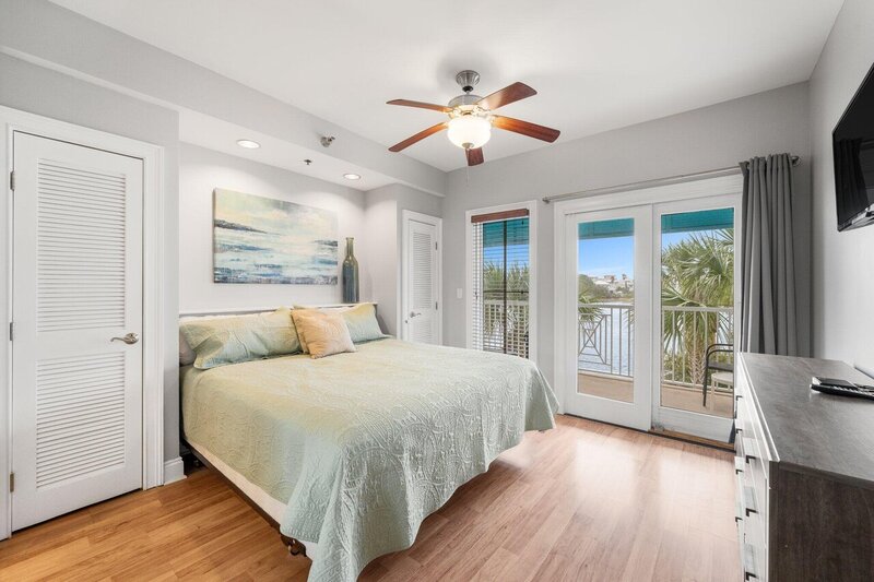 bedroom with king bed over looking lake