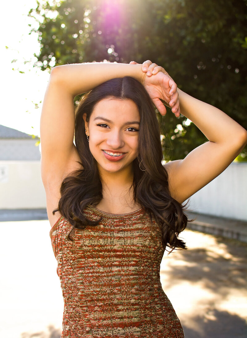 Senior Photographer Riverside & Corona CA |Girl with her arms over her head smiling