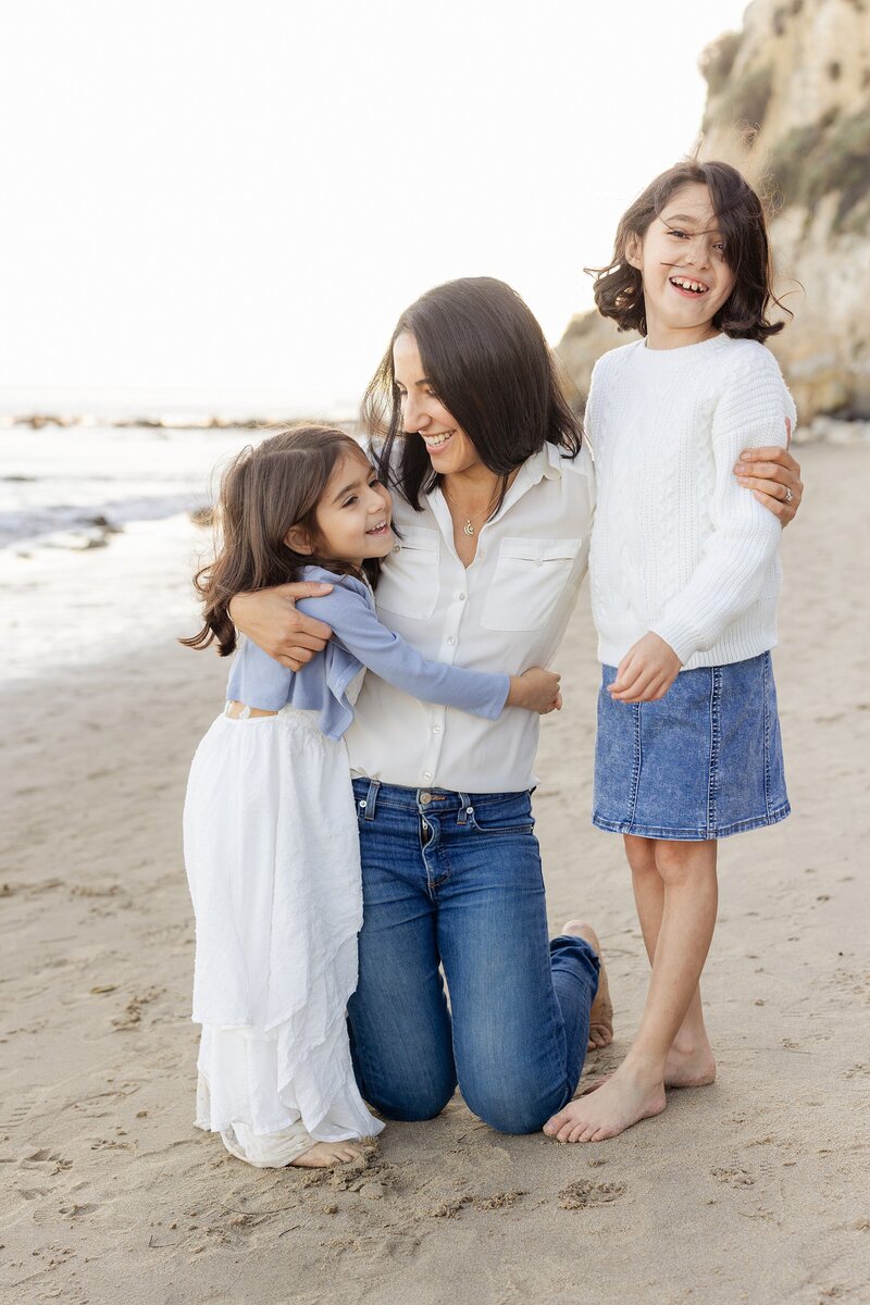 clean and crisp Malibu family photo of mom and daughters on the beach